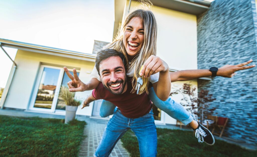 Happy,Young,Couple,Holding,Home,Keys,After,Buying,Real,Estate